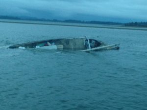 The Pacific Rim, a 60-foot commercial fishing vessel homeported in Westport, Wash., lies partially submerged near the Westport Marina in Grays Harbor, Oct. 23, 2016. The Coast Guard rescued the only person aboard and transferred him to emergency medical services. U.S. Coast Guard photo by Petty Officer 2nd Class Robert Beresh.