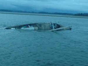 The Pacific Rim, a 60-foot commercial fishing vessel homeported in Westport, Wash., lies partially submerged near the Westport Marina in Grays Harbor, Oct. 23, 2016. The Coast Guard rescued the only person aboard and transferred him to emergency medical services. U.S. Coast Guard photo by Petty Officer 2nd Class Robert Beresh.