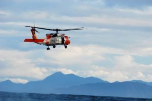 ASTORIA, Ore. - A Coast Guard MH-60 Jayhawk helicopter crew from Air Station Astoria, search for a man overboard dummy during a training exercise with the Columbia River Bar Pilots west of the Columbia River entrance, Nov. 8, 2010. The Coast Guard and Columbia River Bar Pilots began conducting the semi-annual joint drill in 2009 and continue to practice man overboard retrieval techniques to ensure that procedures for locating a person in the water will run smoothly as the two forces work together.U.S. Coast Guard photo by Petty Officer 3rd Class Nate Littlejohn